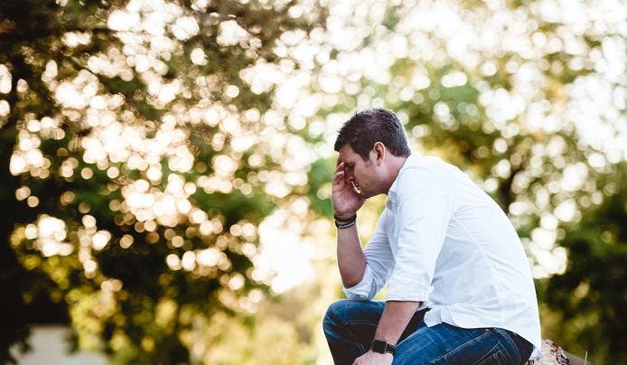 an image of a person holding his head wondering how to improve memory