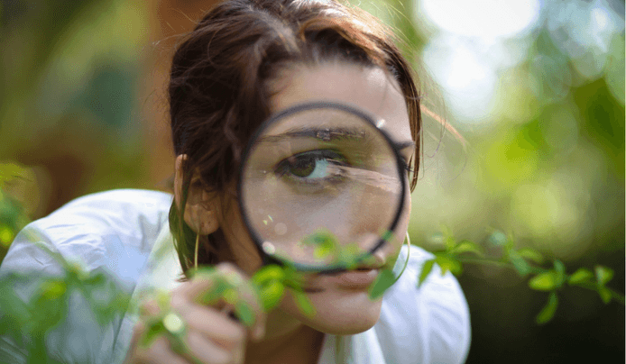 A woman looking through a magnetic lense