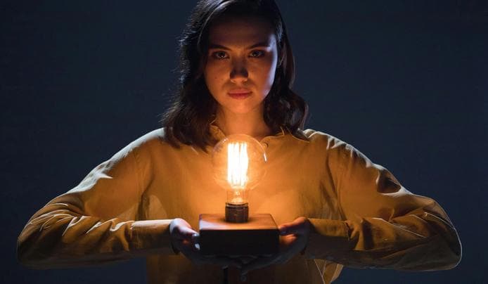 an image of a person holding a light bulb