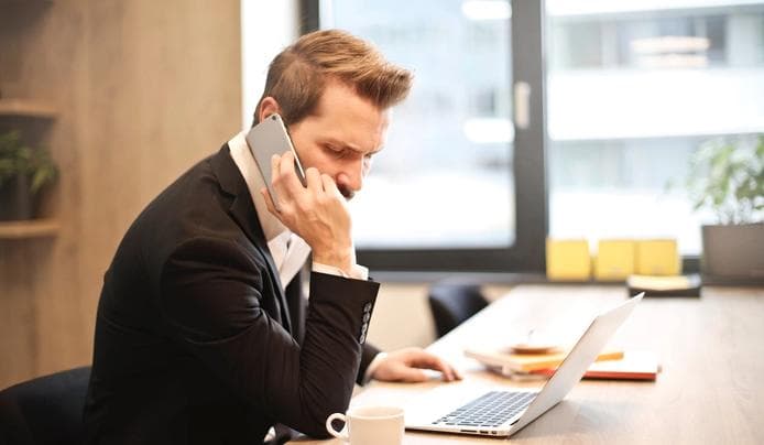 A person talking on the phone while working