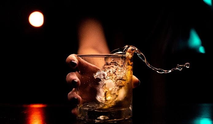 an image of a alcohol glass spilled from putting it on the table