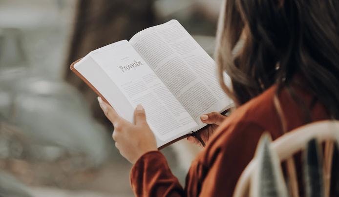 an image of a  woman reading a book