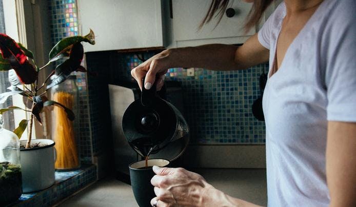 A woman making a coffee