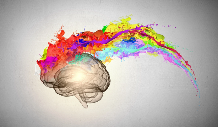 An artistic representation of a brain with vibrant splashes of colorful paint