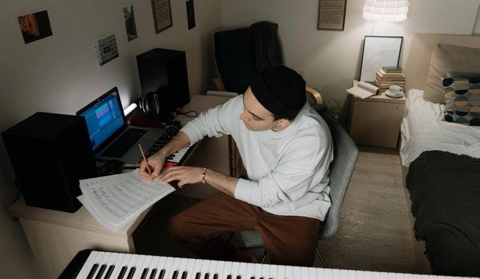 Songwriter writing a song demonstrating his musical intelligence