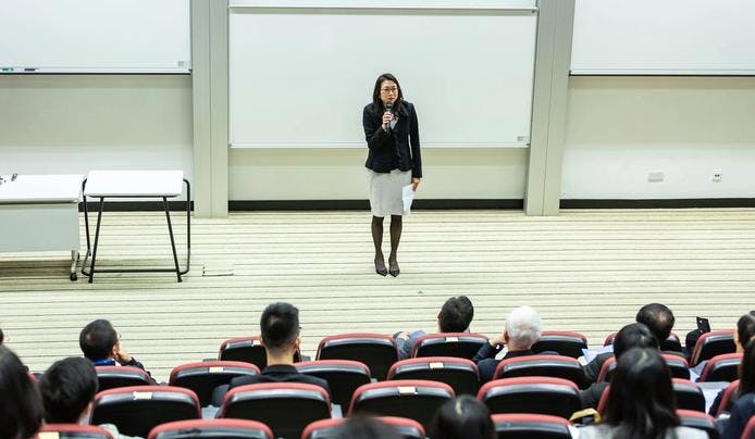 A teacher giving a lecture to a class