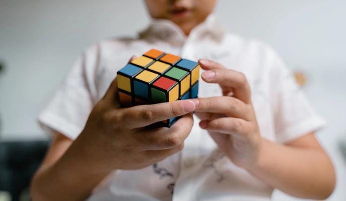 A kid solving a rubik's cube